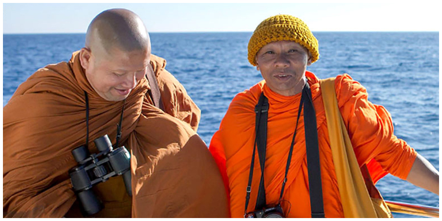 Two monks pose for a photograph while on a Southern California whale watching boat trip.